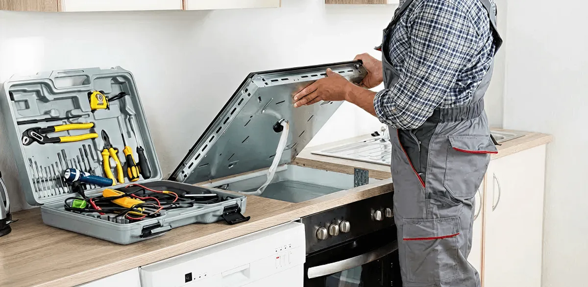 Handyman repairing a cooktop and checking wiring connections in Spokane, WA