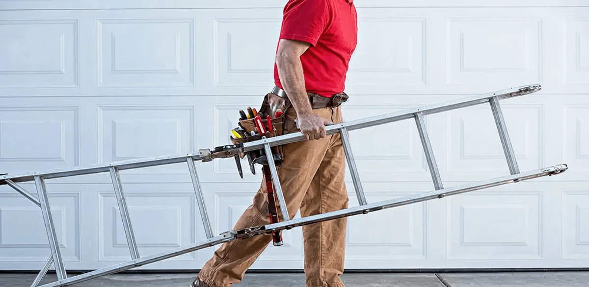 Garage door repair technician arriving with tools and ladder in Spokane, WA