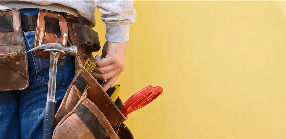Handyman with tool belt ready for home repairs and maintenance in Spokane, WA